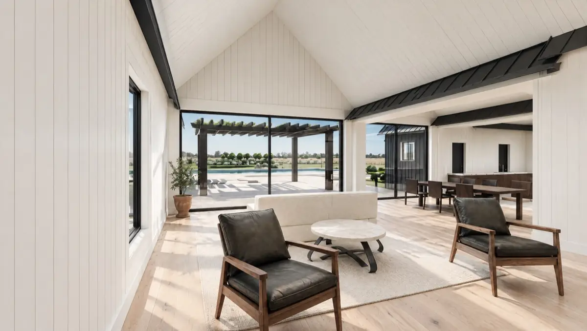 Great room of the modern farmhouse with a vaulted white ceiling